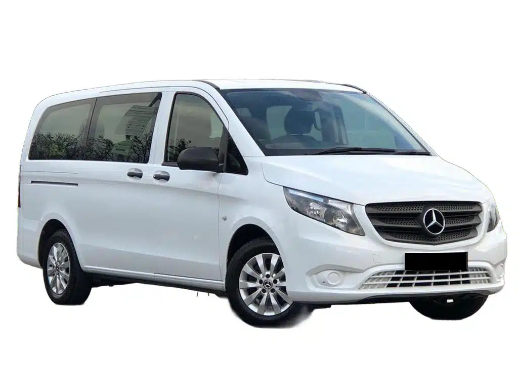 Professional minibus driver assisting passengers travelling from Hull to Manchester Airport